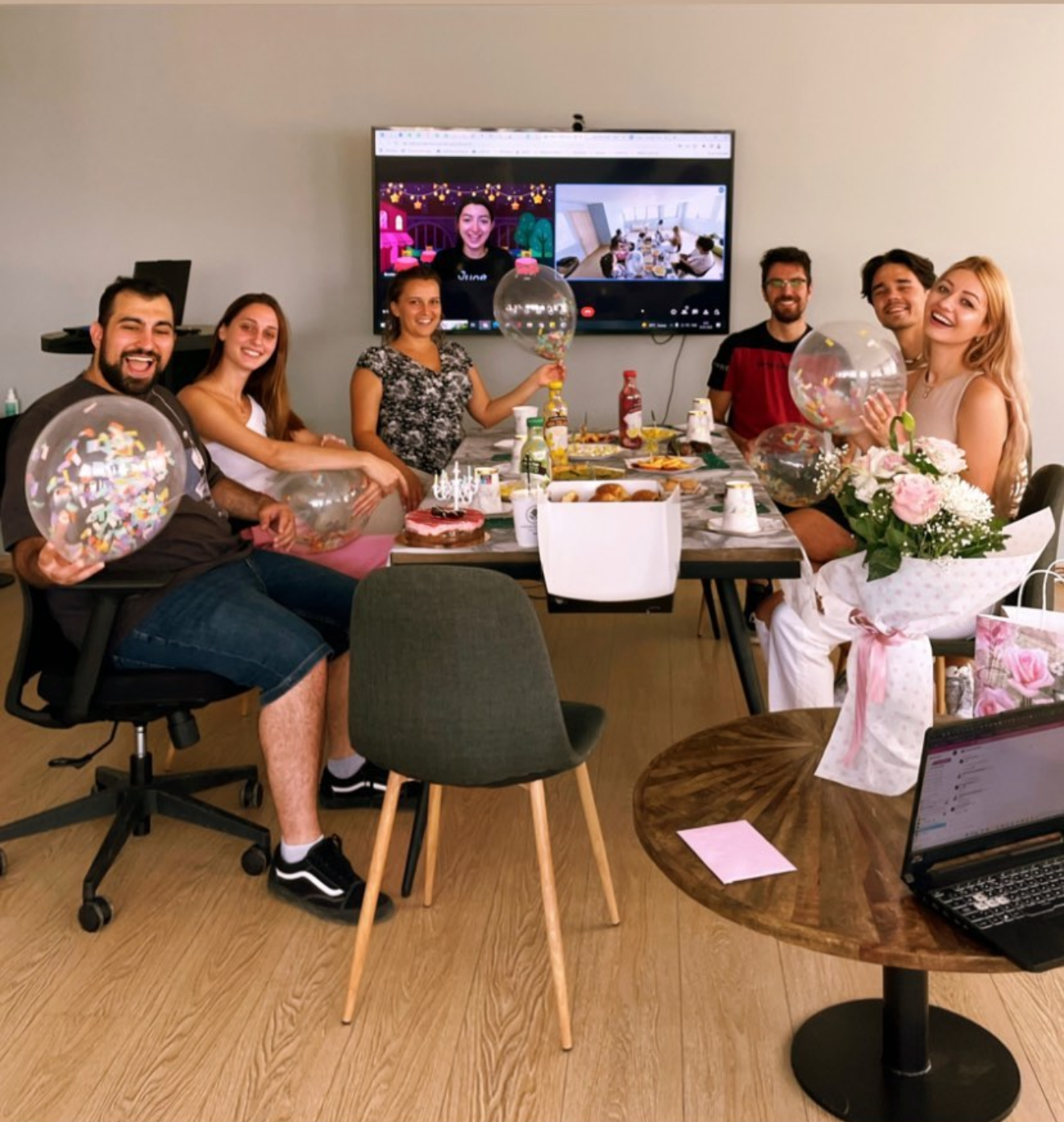 June Homes team celebration with remote colleagues joining on screen